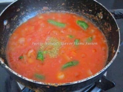 Aromatic Chicken Ghee Roast: A Flavorful Indian Recipe - Plattershare - Recipes, food stories and food lovers Aromatic Chicken Ghee Roast cooking in a pan with vibrant spices and herbs.