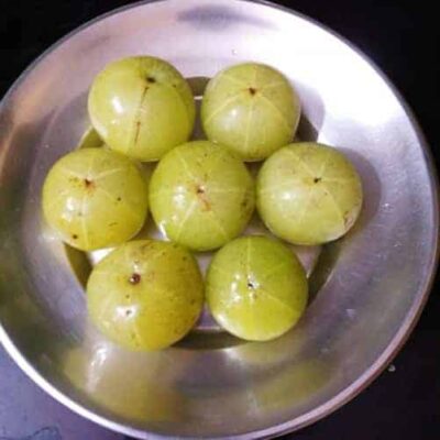 Sweet and Tangy Indian Amla Candy (Gooseberry) - Plattershare - Recipes, food stories and food lovers Amla candy in a stainless steel bowl, showcasing the glossy, green Indian gooseberries used in the r.