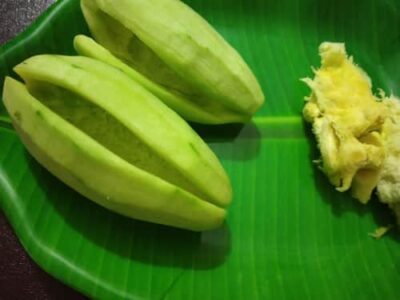 Mawa-Stuffed Sweet Pointed Gourd (Pataler Mishti) - Plattershare - Recipes, food stories and food lovers Stuffed Sweet Pointed Gourd (Pataler Mishti) on a green banana leaf.