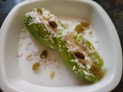 Mawa-Stuffed Sweet Pointed Gourd (Pataler Mishti) - Plattershare - Recipes, food stories and food lovers Stuffed Sweet Pointed Gourd (Pataler Mishti) in a white dish.