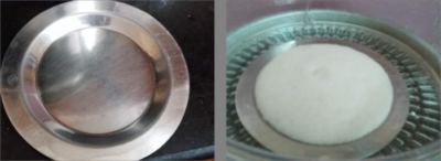 Authentic Thatte Idli: Soft, Flat, and Flavorful South Indian Crepes - Plattershare - Recipes, food stories and food lovers Traditional Thatte Idli batter in a steel mold, ready to be steamed.