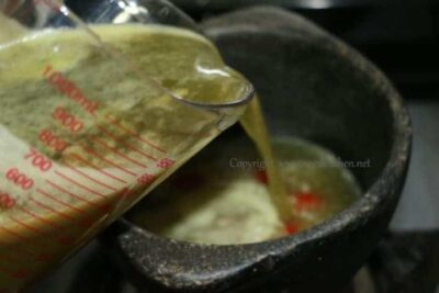 Revitalizing Wheatgrass Rasam: A Tangy South Indian Soup - Plattershare - Recipes, food stories and food lovers Wheatgrass Rasam in a traditional South Indian style, served hot in a rustic pot.