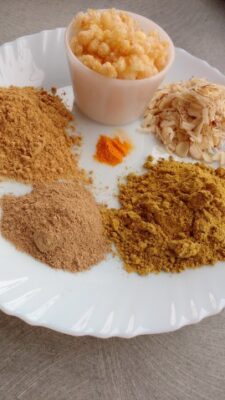 Nutritious Postpartum Katlu: A Traditional Gujarati Sweet Treat - Plattershare - Recipes, food stories and food lovers Traditional Gujarati postpartum sweet katlu with various ingredients on a white plate.
