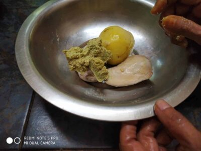 Nutrient-Rich Rajgira Tikki (Amaranth Fritters) for Fasting and Everyday Meals - Plattershare - Recipes, food stories and food lovers Uncooked chicken with spices, ginger, garlic and potato in a metal bowl ready for cooking.