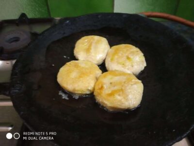 Nutrient-Rich Rajgira Tikki (Amaranth Fritters) for Fasting and Everyday Meals - Plattershare - Recipes, food stories and food lovers Golden fried snack being cooked on a black cast-iron skillet, crispy and delicious looking.