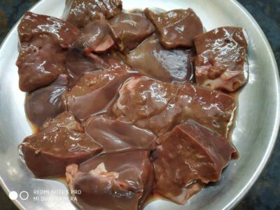 Kaleji Keema Balls: A Flavorful Mutton Recipe - Plattershare - Recipes, food stories and food lovers Raw chicken hearts marinated in spices, ready for cooking, on a stainless steel plate.