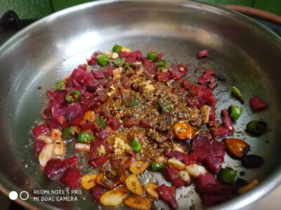 Healthy & Hearty Wheat Dalia with Roasted Cumin and Beets - Plattershare - Recipes, food stories and food lovers Sautéed diced meat with green chilies, garlic, and spices in a stainless steel pan.