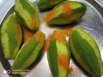 Flavorful Pointed Gourd (Parwal) with Aromatic Spices - Plattershare - Recipes, food stories and food lovers Fresh green mangoes with chili powder and salt, ready for a tangy, spicy snack.