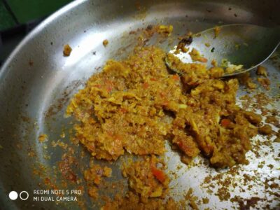 Flavorful Pointed Gourd (Parwal) with Aromatic Spices - Plattershare - Recipes, food stories and food lovers Spiced vegetable mixture cooking in a stainless steel skillet with a spoon.