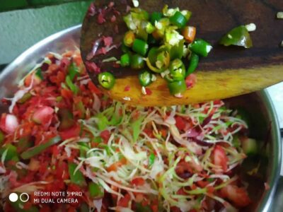 Savory Waffles with Herbed Veggie Topping - Plattershare - Recipes, food stories and food lovers Chopped green chilies on a cutting board with a colorful vegetable salad in a bowl.