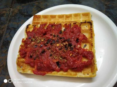 Savory Waffles with Herbed Veggie Topping - Plattershare - Recipes, food stories and food lovers Creamy waffle topped with spicy tomato sauce and herbs on white plate.