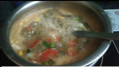 Nourishing Turmeric Sweet Potato & Bok Choy Soup - Plattershare - Recipes, food stories and food lovers Boiling vegetable soup with carrots, green beans, and corn in a stainless steel pan.