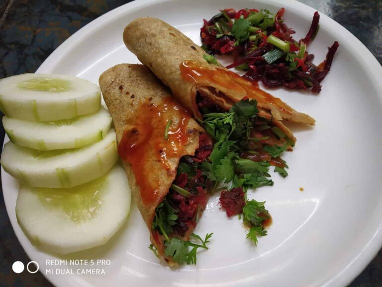 Savory Stuffed Chapati: A Quick & Healthy Indian Flatbread - Plattershare - Recipes, food stories and food lovers Crispy vegetable stuffed dosa with fresh cucumber slices and tangy chutney on white plate.