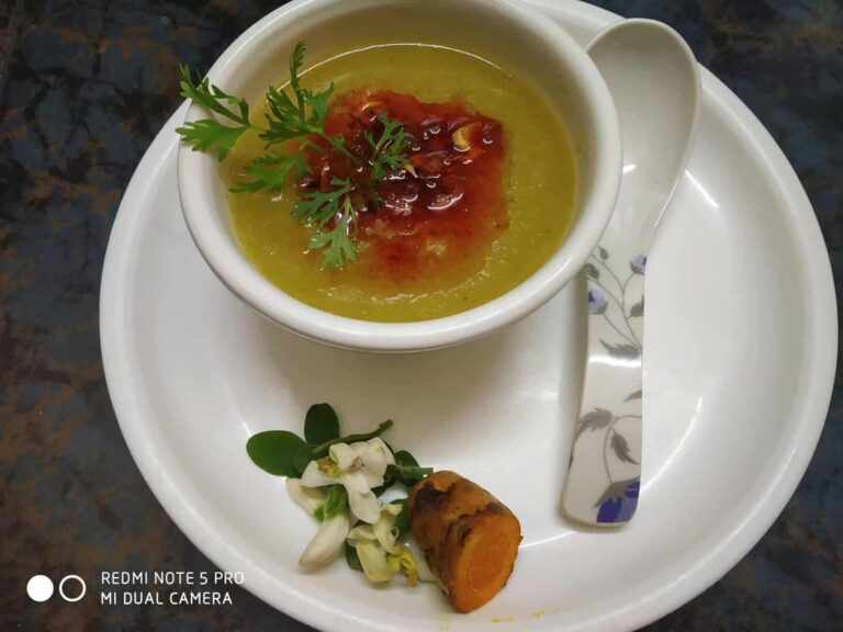 Nutritious & Flavorful Moringa Flower Soup (Quick & Easy) - Plattershare - Recipes, food stories and food lovers Silkworm pupae soup garnished with herbs served in a white cup with a small flower and root on a white plate.