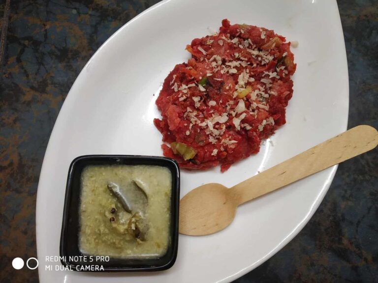 Vibrant Beetroot Pancakes with Coconut & Cumin - Plattershare - Recipes, food stories and food lovers Spicy tomato chutney with chopped onions served on a white plate with a wooden spoon.