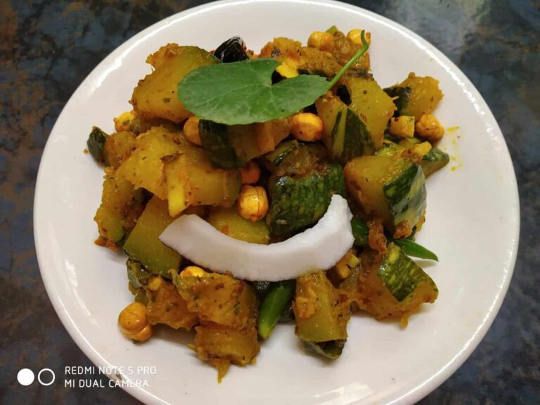 Gotu Kola Pumpkin Stir-Fry: A Flavorful Ayurvedic Dish - Plattershare - Recipes, food stories and food lovers Spicy stuffed cucumber with chickpeas and herbs on a white plate for Indian vegetarian cuisine.