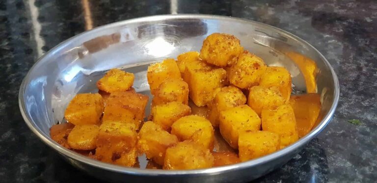 Crispy Paneer Bites: 5-Minute Indian Snack Recipe - Plattershare - Recipes, food stories and food lovers Crispy, spiced fried potatoes served in a stainless steel bowl on a black marble countertop.