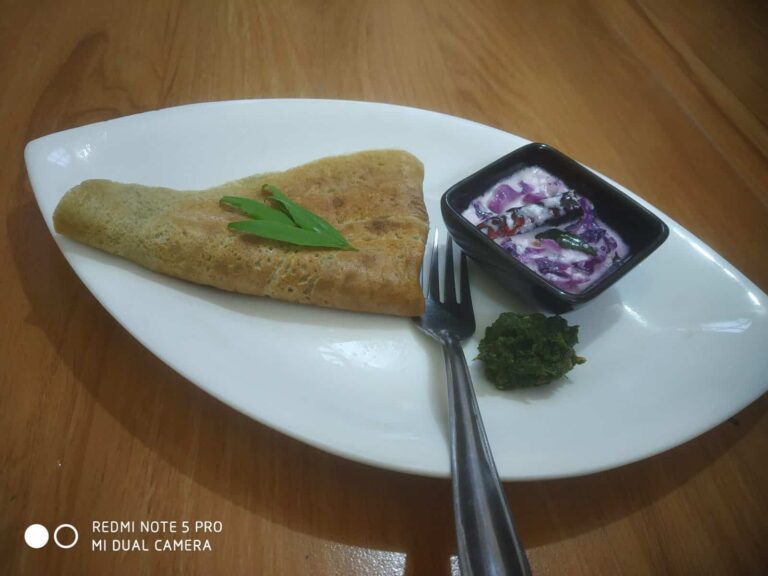 Vibrant Red Cabbage Raita: A Refreshing and Healthy Indian Side Dish - Plattershare - Recipes, food stories and food lovers Delicious savory stuffed pancake served with spicy yogurt and chutney on a white plate.