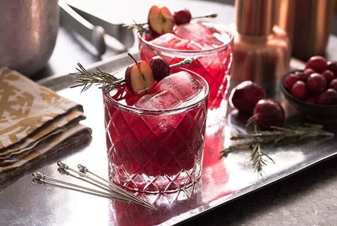 Raise a Glass Without the Buzz: Best Mocktails and Non-Alcoholic Drinks for Any Occasion - Plattershare - Recipes, food stories and food lovers Fresh cherry cocktails garnished with cherries and rosemary on a metal tray.