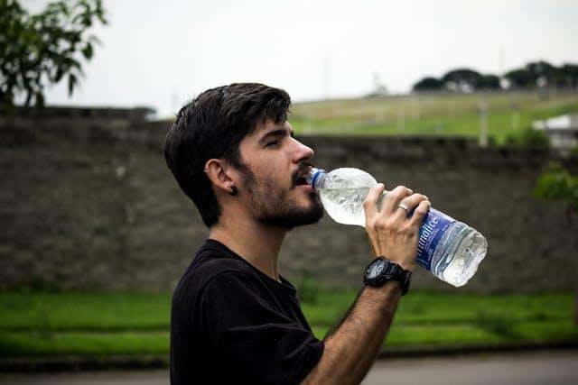 A man drinking water from a bottle