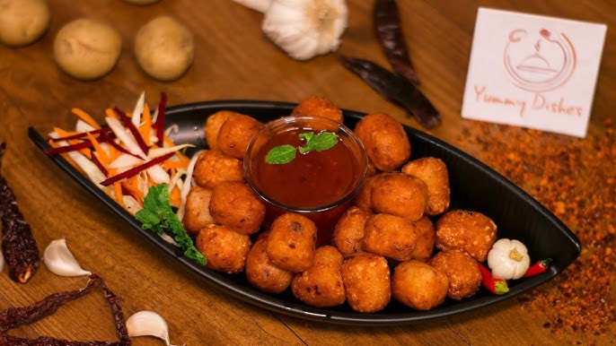 Crispy Chili Garlic Potato Shots (ITC Master Chef Style) - Plattershare - Recipes, food stories and food lovers Golden crispy potato bites with spicy dipping sauce on a black plate.