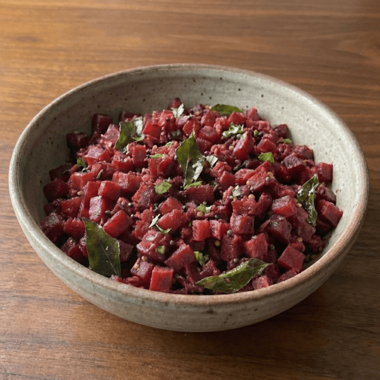 Simple Beetroot Poriyal - Plattershare - Recipes, food stories and food lovers Shredded beetroot salad with fresh herbs and spices served in a rustic ceramic bowl. Perfect for healthy, colorful meals.