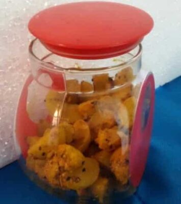 Indian Amla (Gooseberry) pickle in a jar with spices and oil.