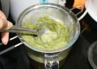 Wheatgrass Rasam in a pot, a tangy South Indian soup, ready to serve.