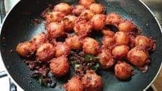 Crispy baby potato bites cooked with beetroot for a spicy, flavorful snack.