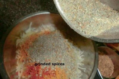 Raw papaya pickle with spices and seasoning in a bowl.