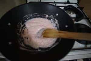 Preparing Rose & Paneer Laddoo in a pan for a traditional Indian sweet.