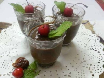 Creamy Vegan Chia Chocolate Pudding with cherries and mint garnish.