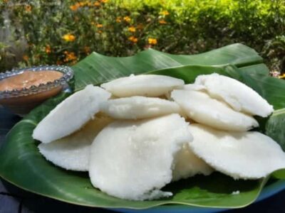 Delicious South Indian melt-in-your-mouth butter idlis served on a banana leaf.