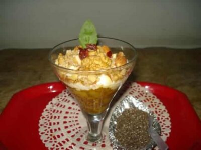Creamy Berry Chia Seed Pudding Parfaits in a glass with fresh berries and whipped cream.