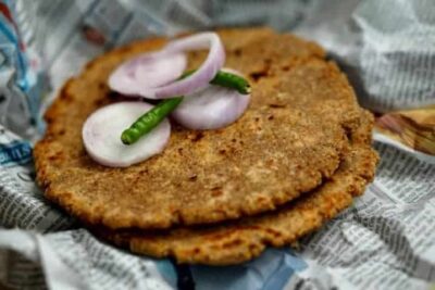 Hirvi Mirchi Cha Thecha (Green Chili Chutney) served with onions and green chilies.
