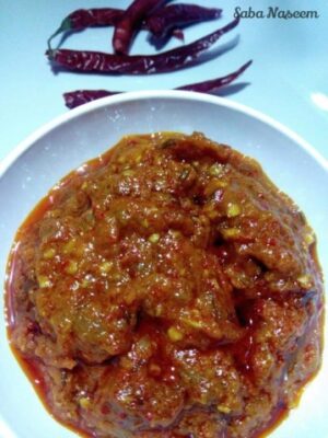 Schezwan sauce in a white bowl, vibrant red color, spicy and flavorful, perfect for enhancing dishes.