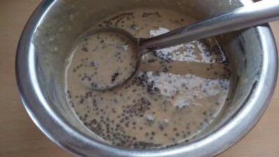 Close-up of chia seed pancake batter with banana and dates in a mixing bowl.