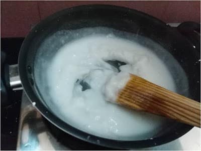 Pots of batter for Pappu Rotta, a South Indian rice and lentil crêpe, being cooked on a stovetop.