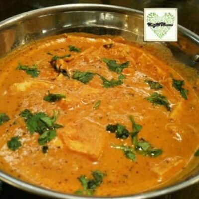 Lasooni Methi Shahi Paneer in a pan, garnished with fresh coriander leaves.