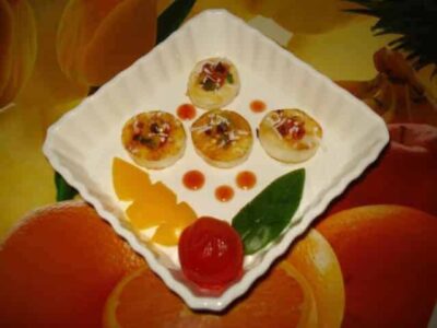 Delicious grilled paneer canapés served on a white plate with garnishes.