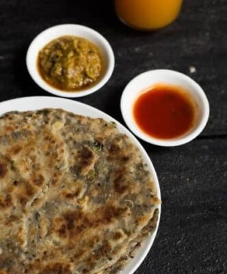 Delicious Indian flatbread with green olives and nigella seeds, served with spicy chutney and tangy.