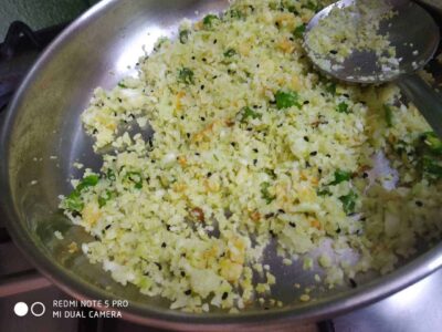 Crushed potatoes with herbs and spices in a stainless steel pan for a delicious recipe preparation.