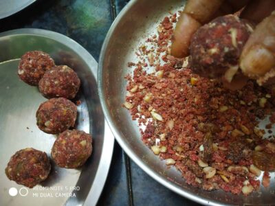 Fresh raw vada mixture with spices and chopped nuts in stainless steel bowl.