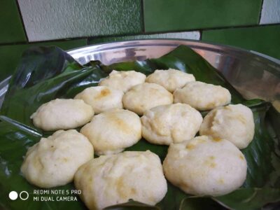Steamed Indian rice cakes served on banana leaves, traditional South Indian snack or breakfast option.