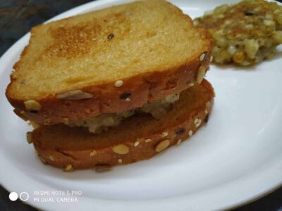 Golden crispy fried bread slices with sesame seeds and a side of spicy vegetable stir-fry.