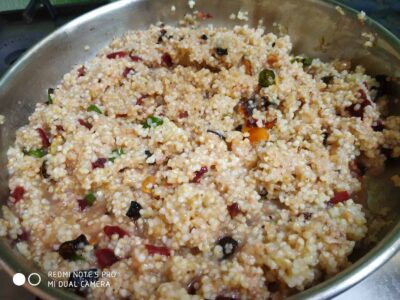 Steamed millet khichdi with vegetables and spices in a stainless steel bowl.