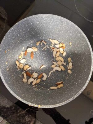 Toasted mixed nuts in a non-stick skillet, ready for snacking or recipe use.
