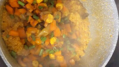 Steamed vegetable curry with carrots, cauliflower, green beans, and onions in spicy sauce.