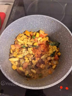 Colorful vegetable stir-fry in a non-stick pan, cooked with spices and fresh ingredients.