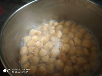Frying golden brown falafel balls in a pan for crispy vegetarian appetizer.
